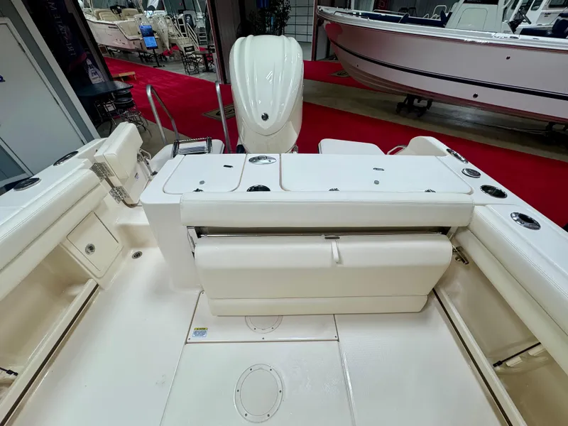 Slide: The Image of 2025 Grady-White Fisherman 236 boat interior with seating and storage, displayed indoors. - 5