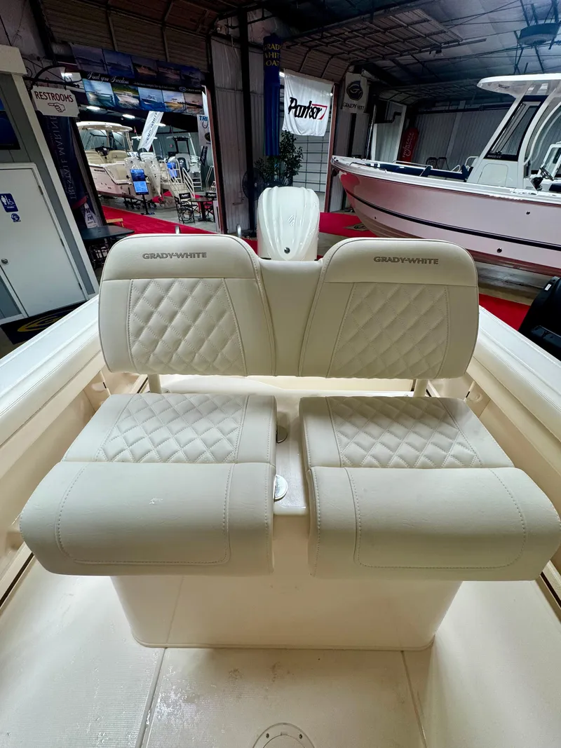 Slide: The Image of 2025 Grady-White Fisherman 236 boat interior with cushioned seating in showroom. - 6