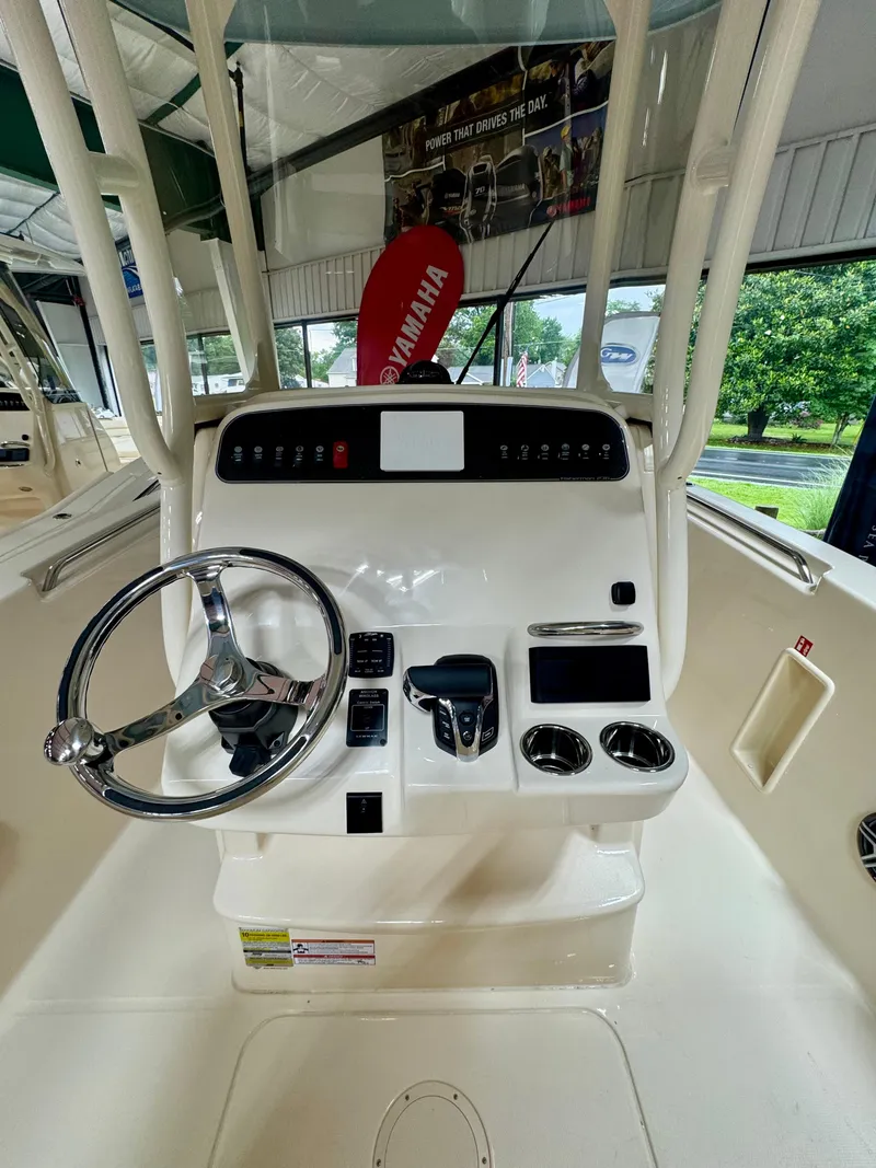 Slide: The Image of 2025 Grady-White Fisherman 236 boat console with steering wheel and controls. - 7