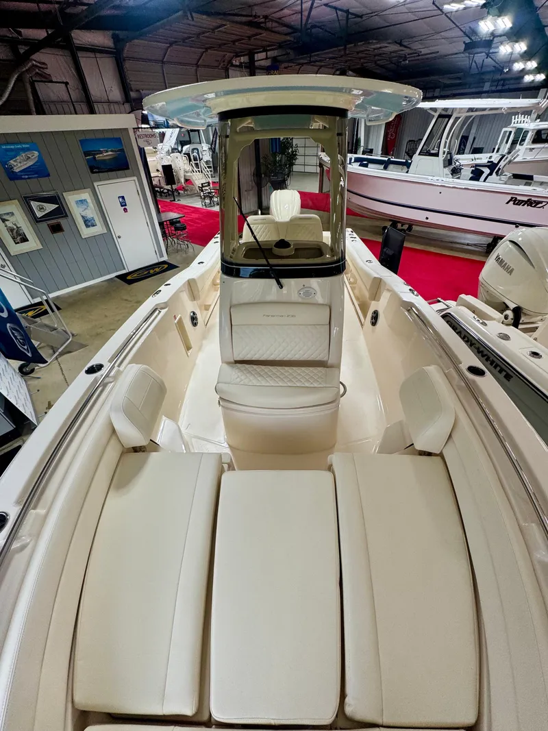 Slide: The Image of 2025 Grady-White Fisherman 236 boat interior with seating and helm in showroom. - 9