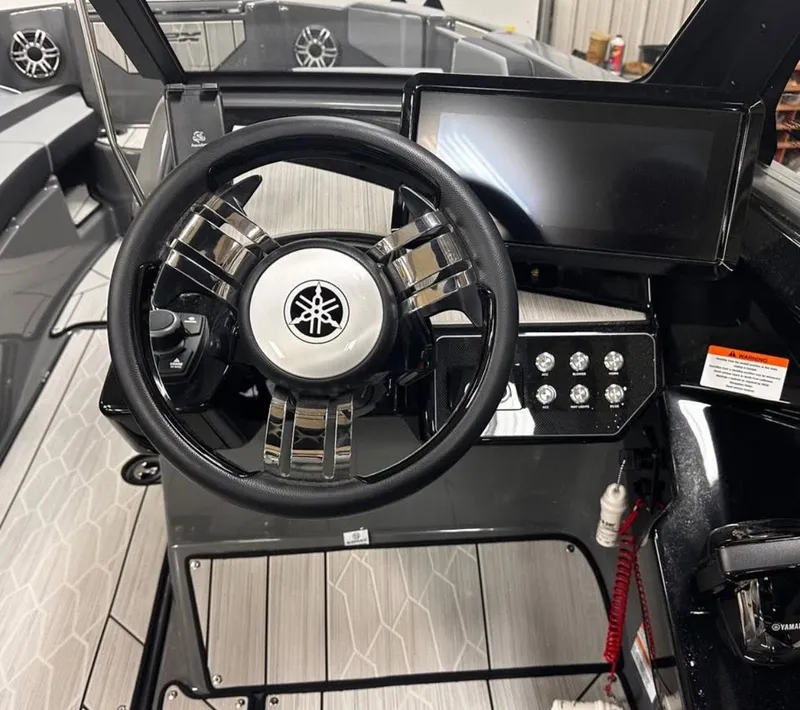 Slide: The Image of Steering wheel and dashboard of 2025 Yamaha Boats 222XD, featuring modern controls and sleek design. - 4