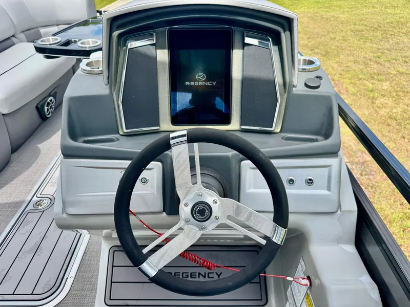 Slide: The Image of Steering console of 2022 Regency 230 LE3 boat with modern dashboard and controls. - 16
