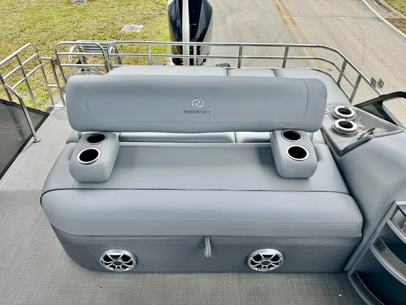 Slide: The Image of Luxurious seating on 2022 Regency 230 LE3 boat with cup holders and speakers. - 19