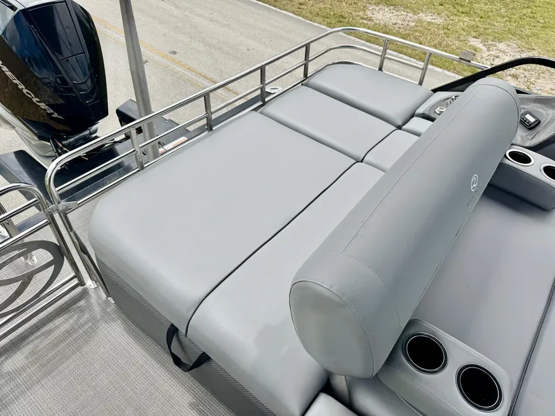 Slide: The Image of 2022 Regency 230 LE3 boat with gray seating and cup holders, featuring a sleek design. - 21