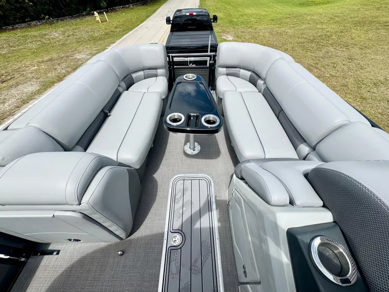Slide: The Image of 2022 Regency 230 LE3 pontoon boat with spacious seating and sleek design. - 7