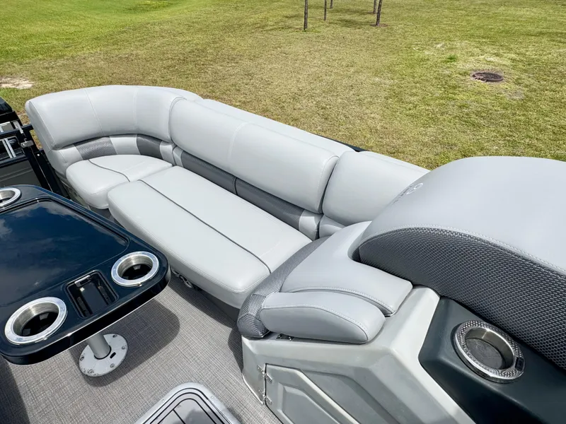 Slide: The Image of Luxurious seating on 2022 Regency 230 LE3 pontoon boat with cup holders and sleek design. - 9