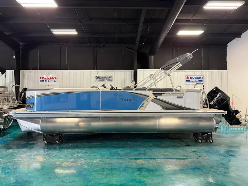 The Image of 2025 Tahoe Pontoon LTZ Cruise boat in showroom, featuring sleek blue and silver design. - 0