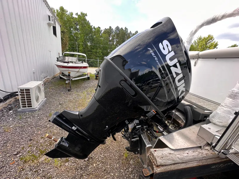 Slide: The Image of 2025 Tahoe Pontoon LTZ Cruise with Suzuki outboard motor in outdoor setting. - 10