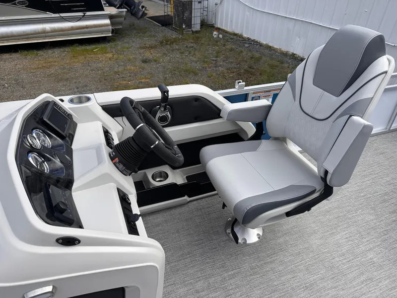 Slide: The Image of 2025 Tahoe Pontoon LTZ Cruise helm with modern steering and comfortable captain's chair. - 7