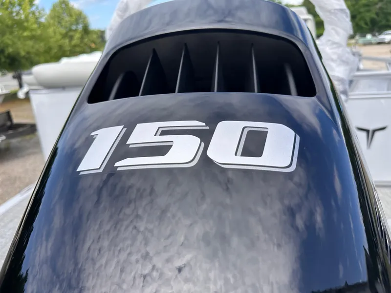 Slide: The Image of Close-up of 2025 Tahoe Pontoon LTZ Cruise engine cover with '150' marking. - 9