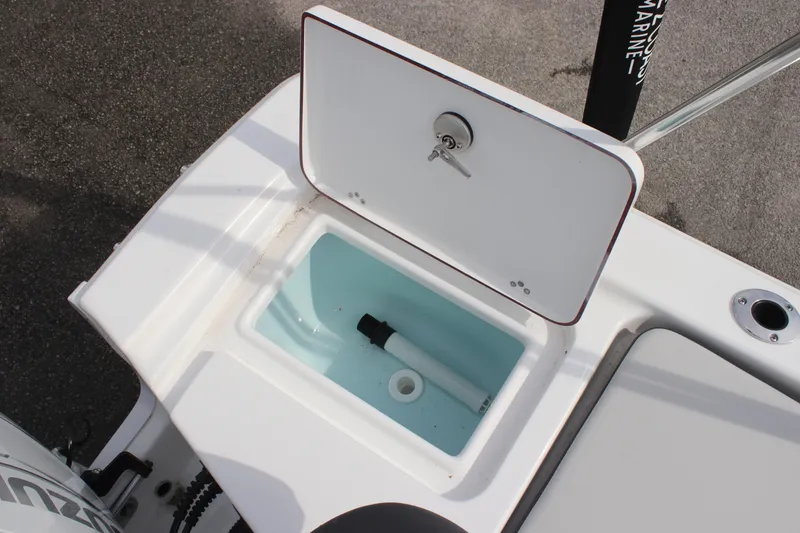 Slide: The Image of 2025 Sea Pro 172 boat livewell with open lid, showcasing interior storage space. - 10