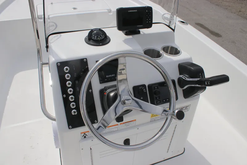 Slide: The Image of 2025 Sea Pro 172 boat console with steering wheel, controls, and navigation equipment. - 11