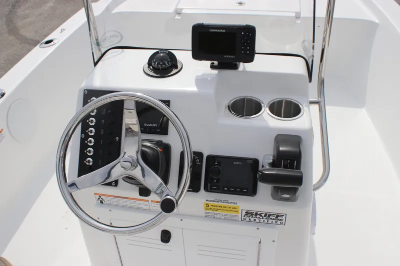 Slide: The Image of 2025 Sea Pro 172 boat console with steering wheel, navigation system, and cup holders. - 13