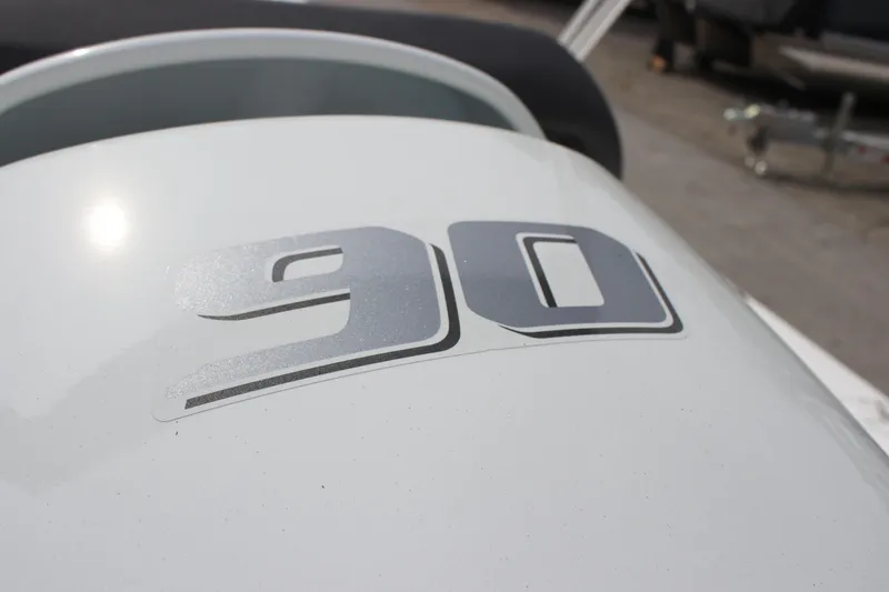 Slide: The Image of Close-up of 2025 Sea Pro 172 boat with '90' decal on white surface. - 14