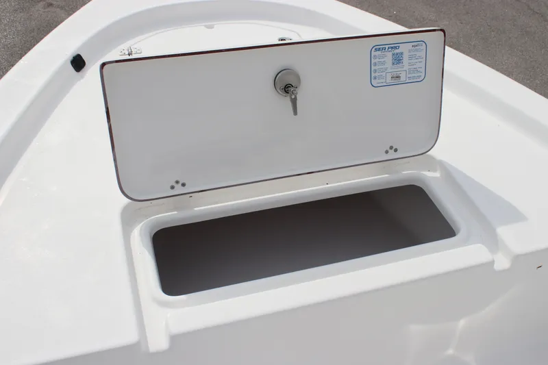 Slide: The Image of 2025 Sea Pro 172 boat storage compartment with open lid and key lock. - 7