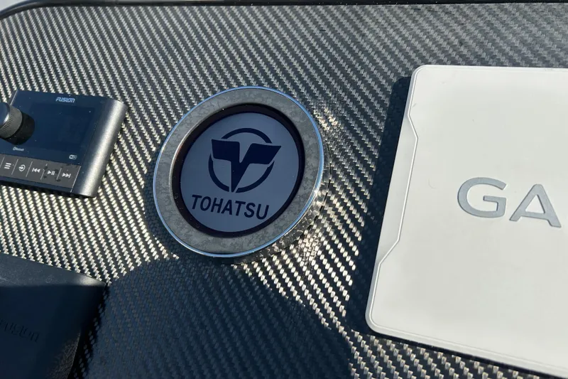 Slide: The Image of Carbon fiber dashboard of 2025 Highfield Sport 520 with Tohatsu logo and Fusion audio controls. - 11