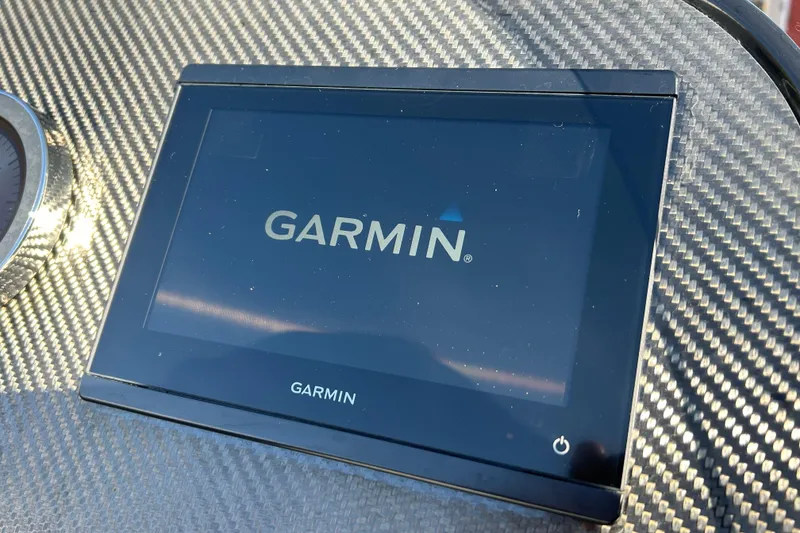 Slide: The Image of Garmin display on 2025 Highfield Sport 520 boat dashboard with carbon fiber finish. - 13