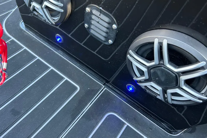 Slide: The Image of 2025 Highfield Sport 520 boat speakers with blue LED lights on deck. - 14