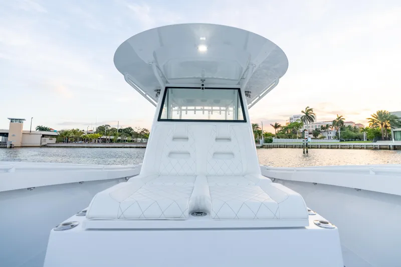 Slide: The Image of 2022 Onslow Bay 41 TE boat with sleek white seating and modern design on calm water. - 10