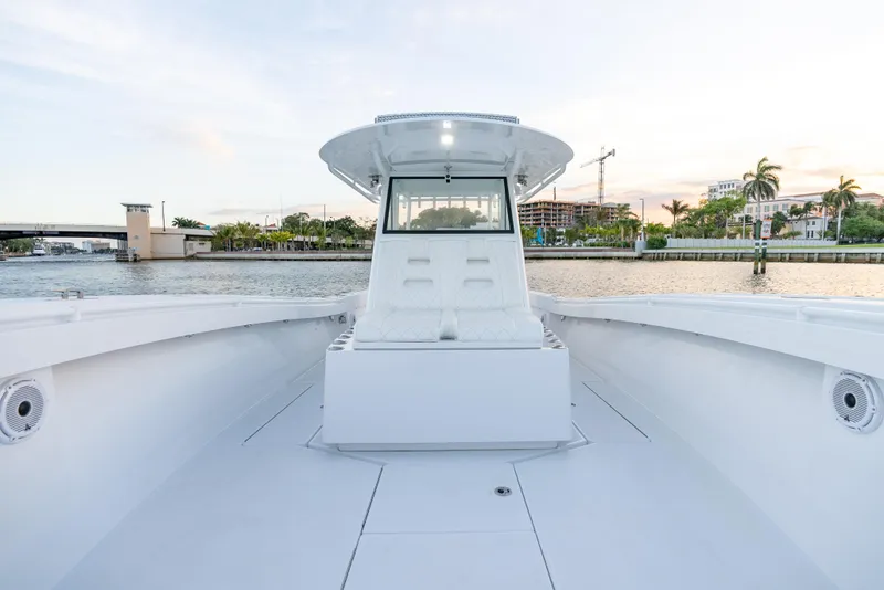 Slide: The Image of 2022 Onslow Bay 41 TE boat on calm water, showcasing spacious deck and modern design. - 11