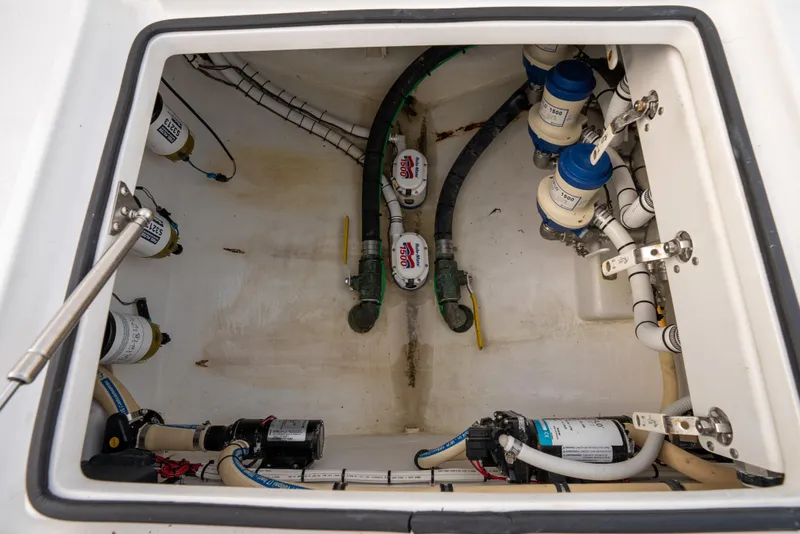 Slide: The Image of Bilge compartment of 2022 Onslow Bay 41 TE boat, showing pumps and plumbing. - 19