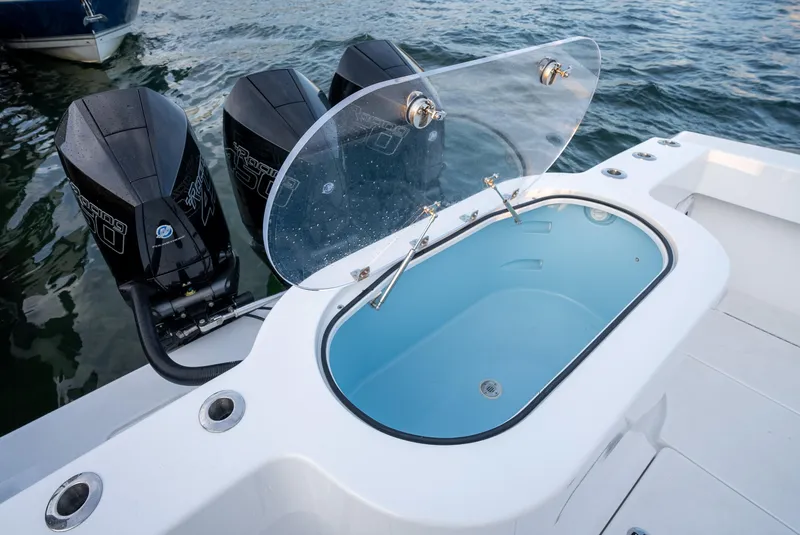Slide: The Image of 2022 Onslow Bay 41 TE boat with open livewell and triple outboard motors. - 20