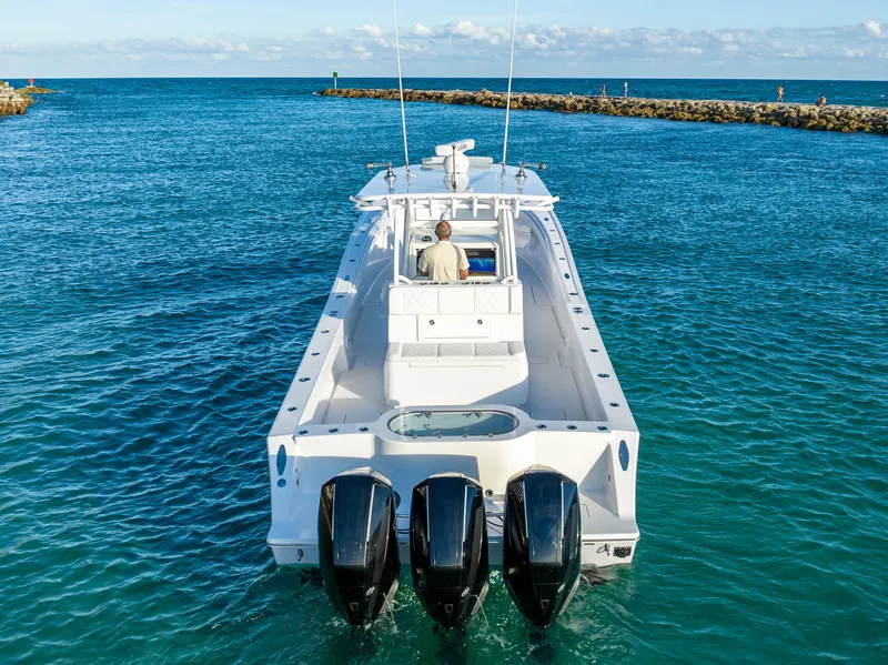 Slide: The Image of 2022 Onslow Bay 41 TE boat with triple engines cruising in clear blue waters. - 6