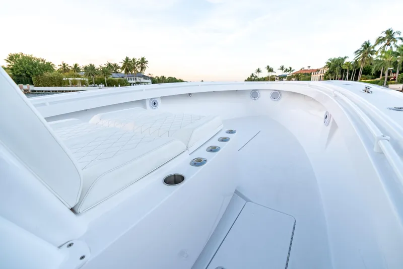 Slide: The Image of 2022 Onslow Bay 41 TE boat interior with white seating and cup holders. - 8