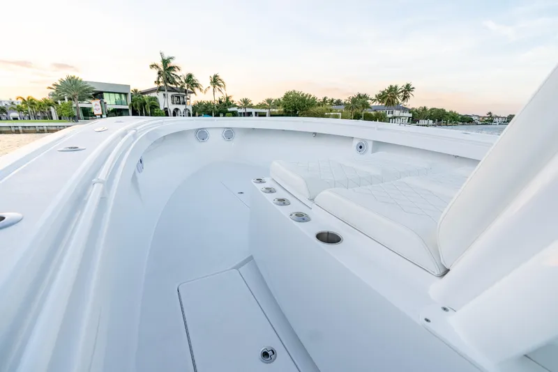 Slide: The Image of 2022 Onslow Bay 41 TE boat interior with white seating and coastal view. - 9