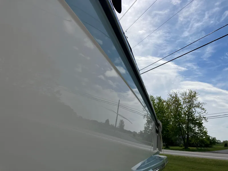 Slide: The Image of 2022 Aviara AV32 OB boat side view under a clear blue sky. - 15