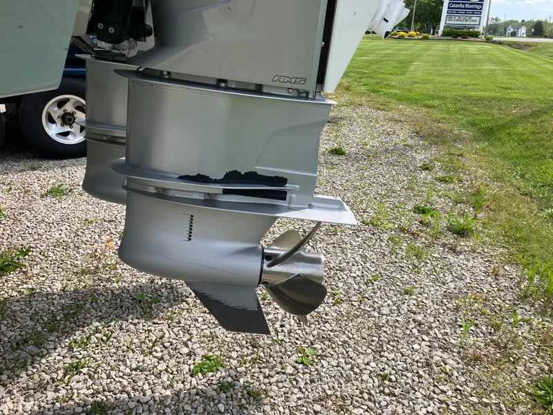 Slide: The Image of Outboard motor of 2022 Aviara AV32 OB on gravel, showcasing propeller detail. - 16