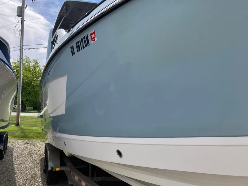Slide: The Image of 2022 Aviara AV32 OB boat on trailer, side view, light blue hull. - 17