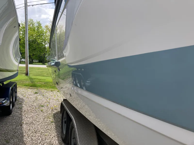Slide: The Image of 2022 Aviara AV32 OB boat side view, parked on a trailer, outdoors. - 18