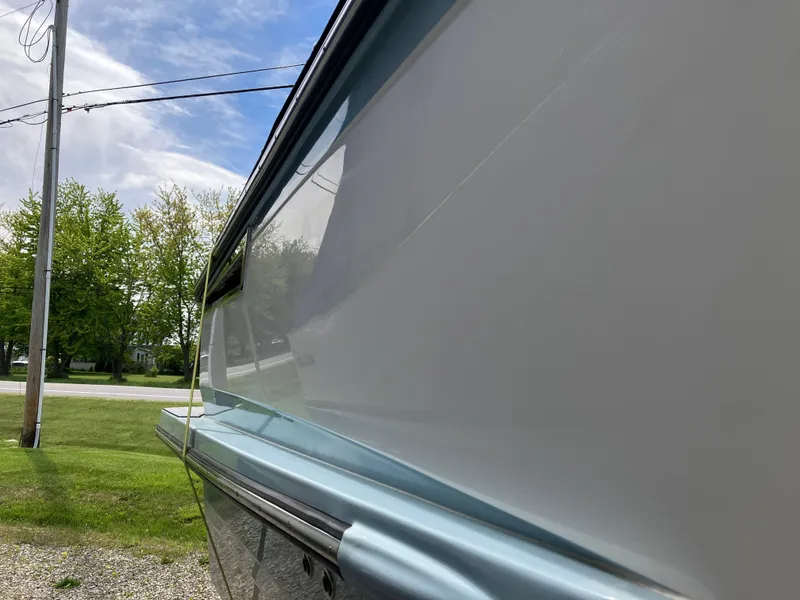 Slide: The Image of 2022 Aviara AV32 OB boat side view with sleek design and glossy finish. - 19