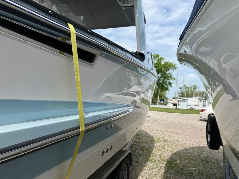 Slide: The Image of 2022 Aviara AV32 OB boat side view, parked outdoors with a yellow strap. - 20