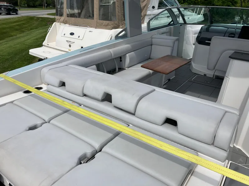 Slide: The Image of 2022 Aviara AV32 OB boat interior with luxurious seating and wooden table. - 21