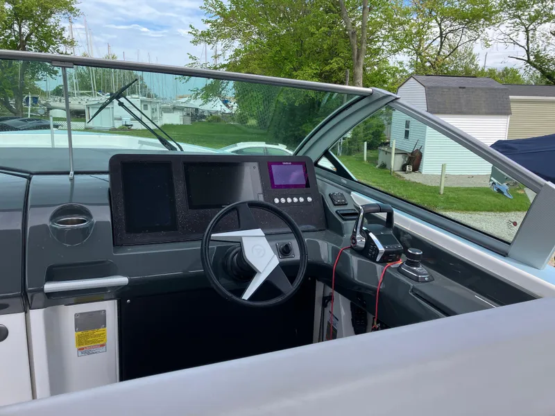 Slide: The Image of 2022 Aviara AV32 OB boat cockpit with modern controls and steering wheel. - 24
