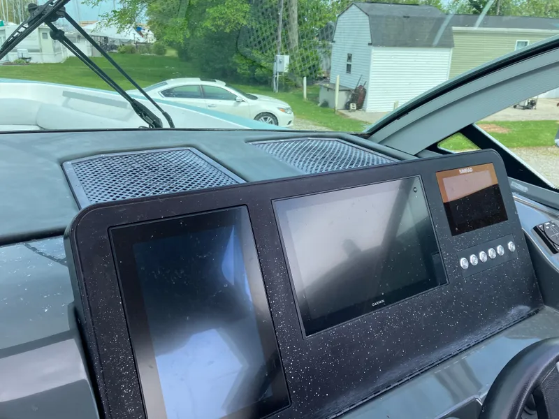 Slide: The Image of Dashboard of 2022 Aviara AV32 OB boat with dual screens and control panel. - 25