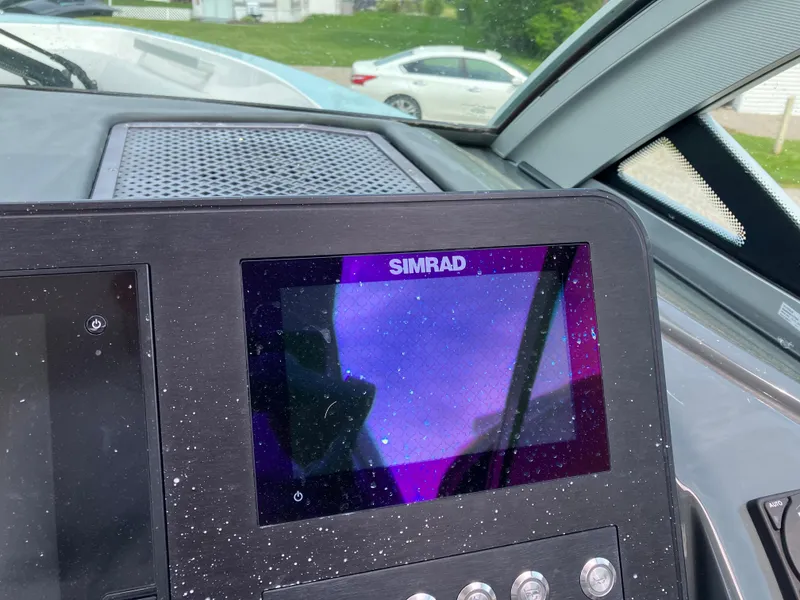 Slide: The Image of Simrad display on 2022 Aviara AV32 OB boat dashboard, showing a purple screen. - 26