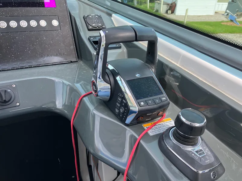 Slide: The Image of Control panel of 2022 Aviara AV32 OB boat with throttle and joystick. - 29