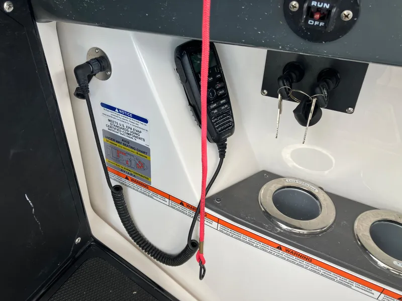 Slide: The Image of Control panel of 2022 Aviara AV32 OB boat with keys and communication device. - 30