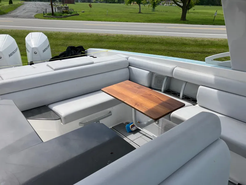 Slide: The Image of 2022 Aviara AV32 OB boat interior with white seating and wooden table. - 31