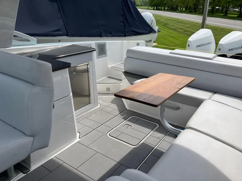Slide: The Image of Luxurious 2022 Aviara AV32 OB boat interior with seating, table, and Mercury outboard engines. - 33