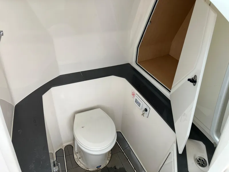 Slide: The Image of 2022 Aviara AV32 OB boat interior with a compact bathroom and toilet. - 36