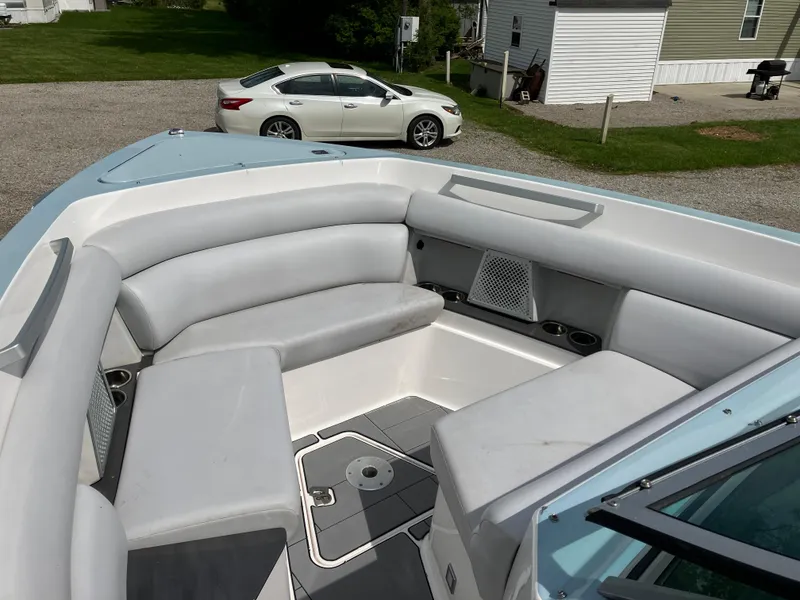 Slide: The Image of 2022 Aviara AV32 OB boat with spacious seating, parked near a white car and house. - 42