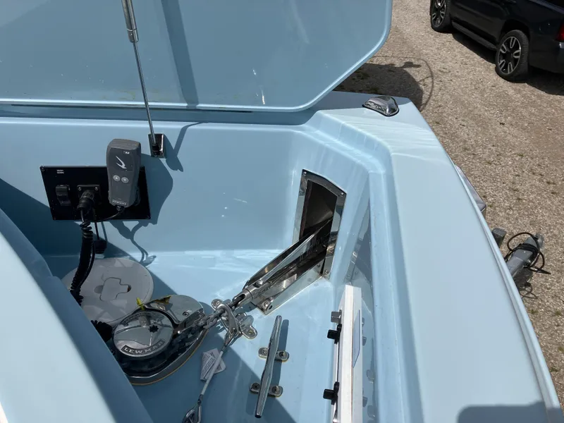 Slide: The Image of 2022 Aviara AV32 OB boat anchor compartment with winch and control panel. - 43