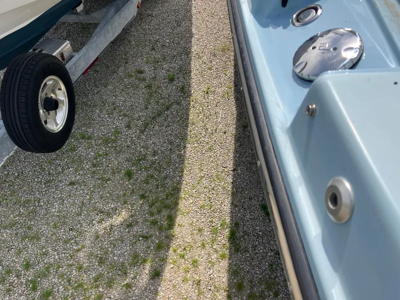 Slide: The Image of 2022 Aviara AV32 OB boat detail with trailer on gravel surface. - 45