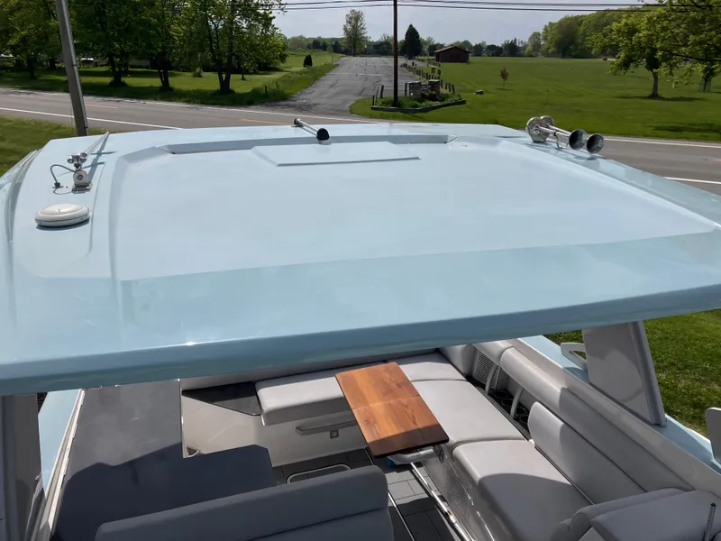 Slide: The Image of 2022 Aviara AV32 OB boat with spacious seating and sleek design on a sunny day. - 48