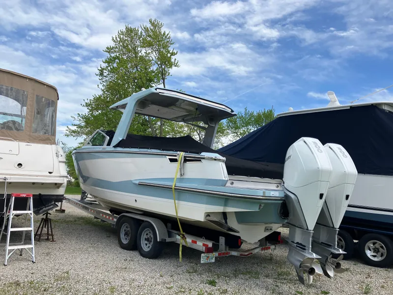 Slide: The Image of 2022 Aviara AV32 OB boat on trailer, parked outdoors under a blue sky. - 9
