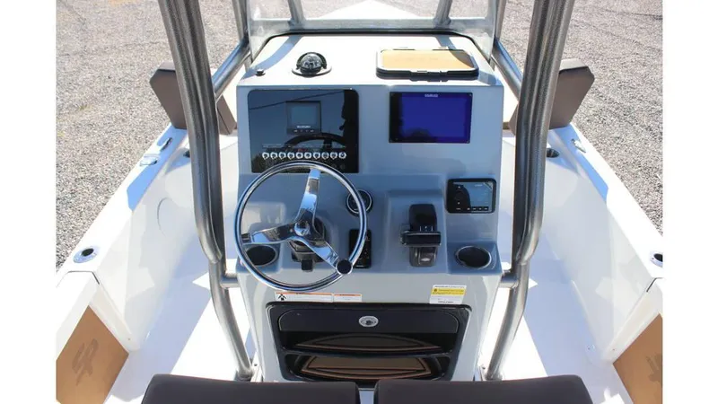 Slide: The Image of 2025 Sea Pro 230 Bay boat console with steering wheel and navigation controls. - 7